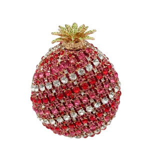 Detailed view of pomegranate shaped evening clutch with red and pink rhinestones
