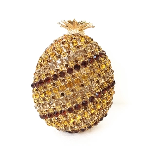Elegant pineapple-shaped evening clutch bag with sparkling gold and amber rhinestones