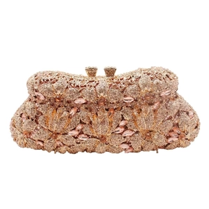 Macro view of rose gold floral evening clutch with intricate rhinestone pave and crystals