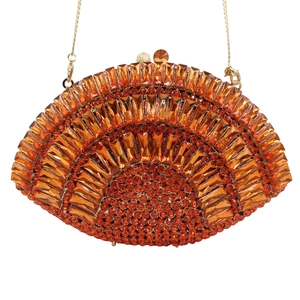 Detail of orange rhinestone evening clutch showing intricate hollow-out crystal patterns