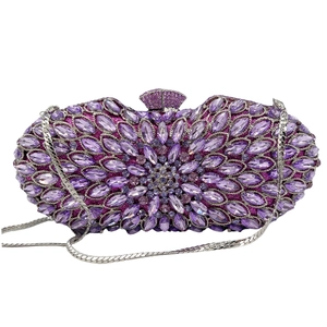 Detail of violet crystal evening bag with floral pattern and silver chain strap