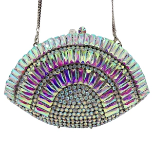 Macro detail of iridescent rhinestones and hollow-out design on fan-shaped clutch