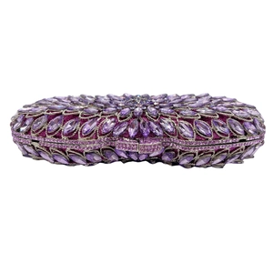 Macro detail of violet crystal evening clutch with marquise floral stone pattern