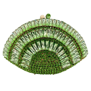 Detailed view of fan-shaped clutch bag with emerald green rhinestones and golden clasp