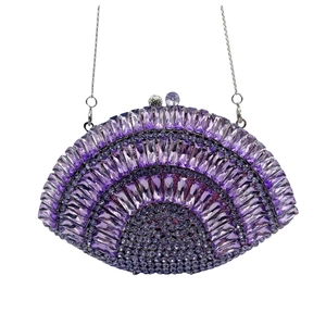 Macro detail of purple crystal clutch bag with geometric rhinestones and silver chain