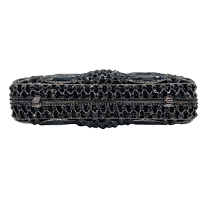 Detail of black rhinestone evening clutch with large faceted gems and gunmetal frame