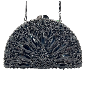 Detail of a semicircular black evening clutch with rhinestone floral pattern and metal chain