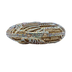 Detailed view of hollow Egyptian cobra evening bag with sparkling rhinestones and gold crystals