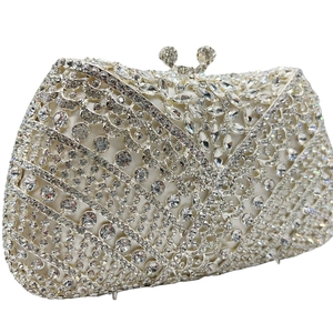 Detailed view of silver crystal evening clutch with intricate rhinestone patterns