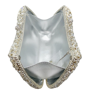 Overhead view of luxury crystal clutch bag with silver lining and interior card pocket