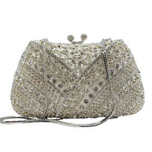 Macro shot of silver crystal clutch bag with intricate rhinestone floral patterns