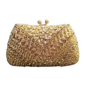 Detail of golden crystal clutch bag showing geometric rhinestone pattern and metal clasp