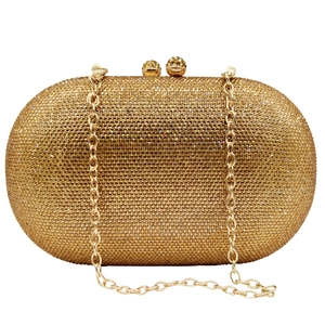 Close-up of golden crystal clutch bag with detachable chain strap for evening events
