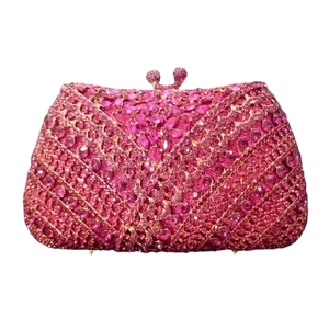 Detail of rose pink crystal clutch with V-shaped rhinestone patterns and luxury ball clasp