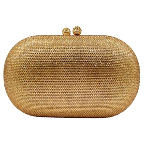 Macro shot of gold crystal clutch bag featuring dense rhinestones and metal ball clasp