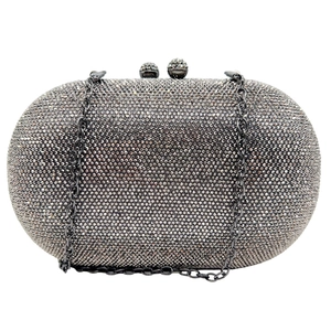 Macro view of crystal clutch bag with grey rhinestones and metal chain strap