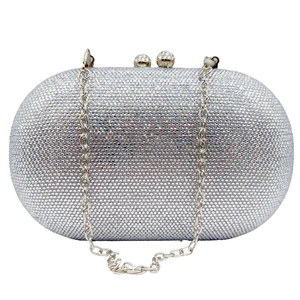 Detailed macro view of silver crystal encrusted oval clutch bag with metal chain