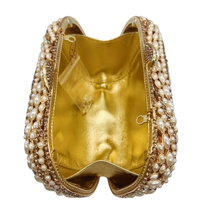 Detailed interior of golden crystal leaf evening clutch with pearls and spare beads