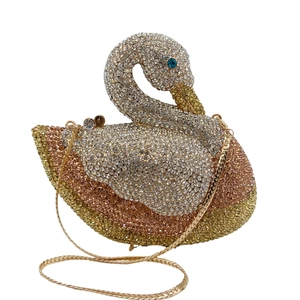 Detailed close-up of a swan-shaped evening bag with gradient crystals and a gold chain