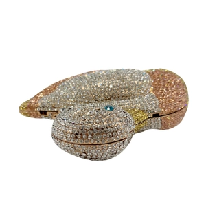 Detailed view of snake-shaped evening clutch bag with gradient crystal rhinestones