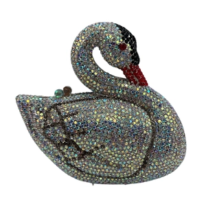 Detail shot of a crystal-encrusted swan evening bag with sparkling rhinestones