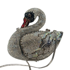 Close-up of elegant swan crystal evening bag with silver chain and intricate rhinestone detail