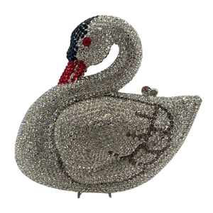 Detailed close-up of crystal-encrusted swan evening bag with red and black rhinestone accents