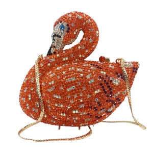 Detailed view of orange swan evening bag with sparkling crystals and golden chain