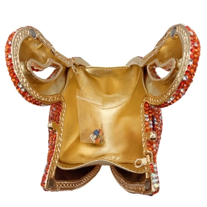 Detailed interior of elephant crystal evening bag with golden lining and spare rhinestones