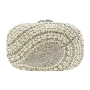 Detailed view of hand-beaded faux pearls and crystals on leaf pattern clutch bag