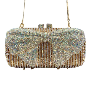 Macro detail of luxury bow evening bag with colorful rhinestones and gold chain