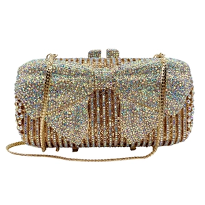 Macro shot of sparkling rhinestones and golden bow buckle on the evening clutch bag