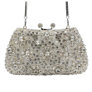 Macro view of crystal flower patterns and silver hardware on this luxury evening clutch bag