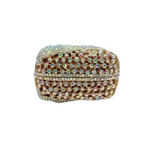 Macro view of crystal encrusted bow on a golden evening clutch bag with AB rhinestones