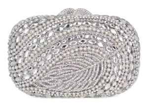 Detail of silver evening bag featuring hollow leaf design with crystals and pearls
