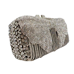 Detail of silver rhinestone evening clutch bag with sparkling crystal bow decoration