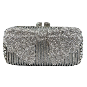 Detailed view of silver evening clutch with sparkling rhinestones and oversized bow