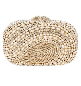 Macro shot of luxury evening clutch with leaf patterns, inlaid pearls, and crystals