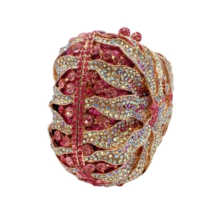 Detail of luxury pink crystal evening clutch bag with intricate petal-shaped rhinestone pattern