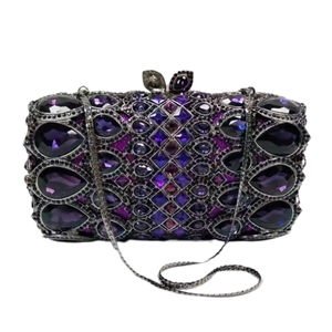 Macro view of purple crystal rhinestones and detachable metal chain on the clutch bag