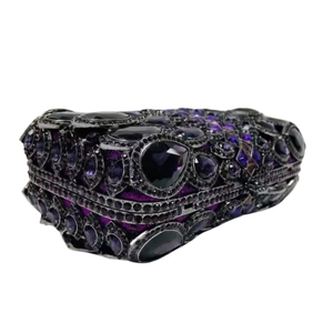Macro view of purple rhinestone embellishments on heart-shaped luxury evening clutch bag
