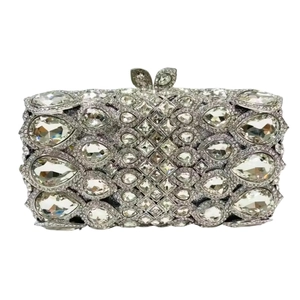 Detail of silver evening clutch bag featuring rhinestone crystals and bow clasp