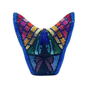 Macro shot of colorful butterfly crystal rhinestones on the evening clutch surface