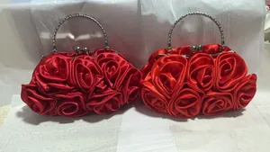 Detailed view of red satin rose evening bag with rhinestone-embellished silver ring handles