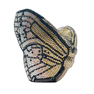 Macro view of crystal butterfly clutch bag with detailed hand-set rhinestone wing pattern