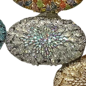 Macro shot of oval evening bags with sparkling crystals and starburst flower patterns