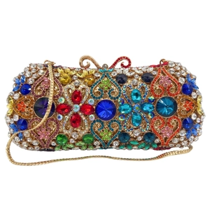 Detail of colorful rhinestones and floral pattern on luxury evening clutch with gold chain