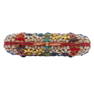 Luxurious oval evening clutch bag encrusted with colorful rhinestones and gold clasp