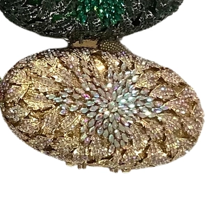 Detail view of champagne gold crystal rhinestones on an oval evening clutch bag