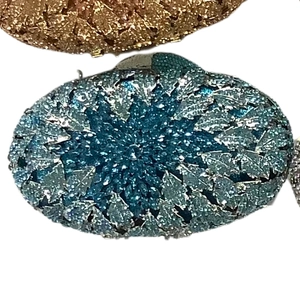 Macro detail of leaf pattern rhinestone evening clutch bag with crystal embellishments